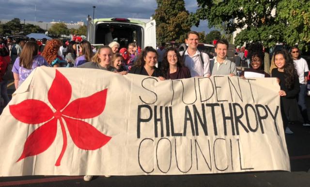 SPC Members with Banner in the Homecoming Parade